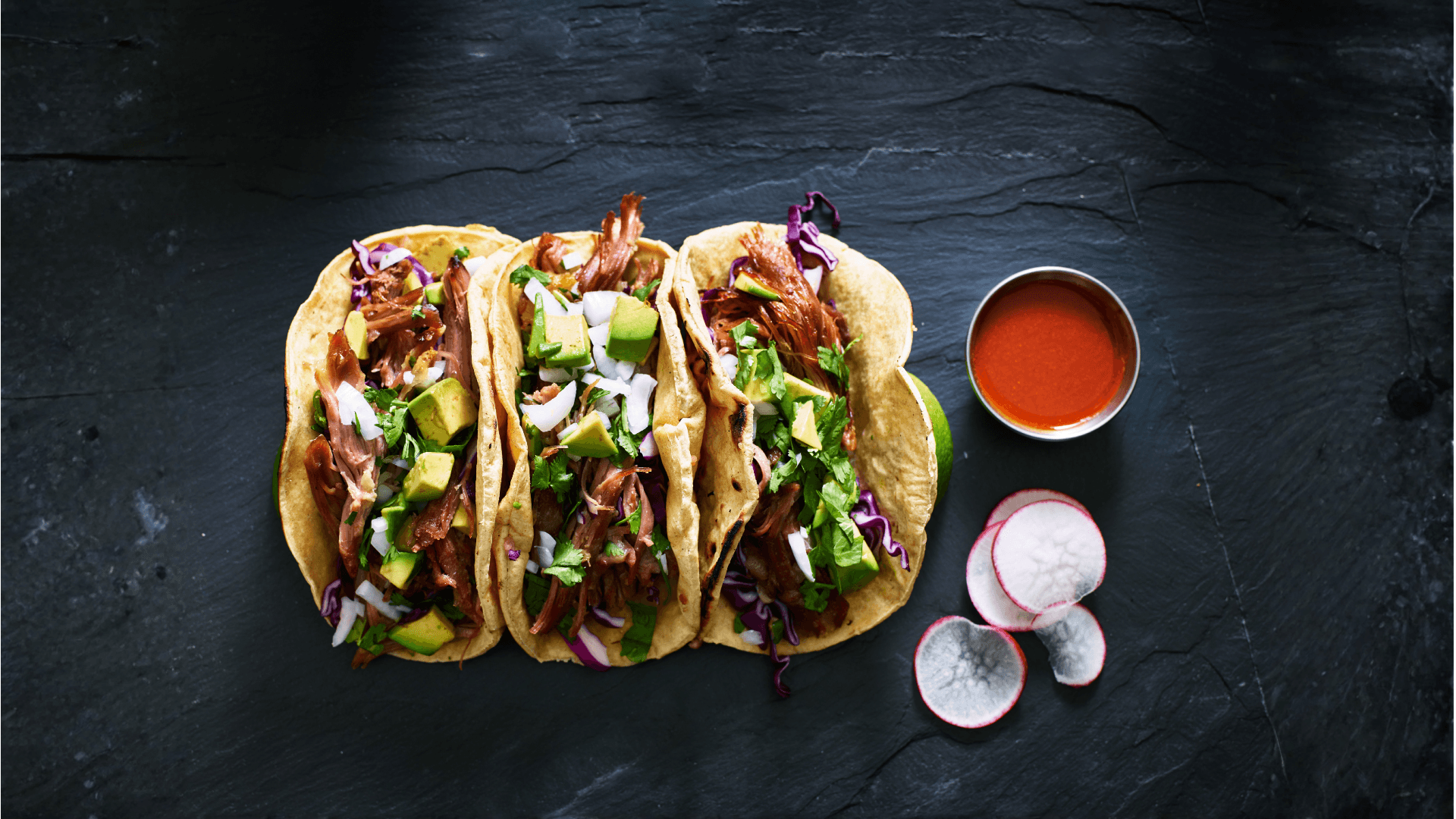 authentic-carnitas-tacos-with-sides-on-wooden-boar-2026-01-08-23-42-52-utc background asset